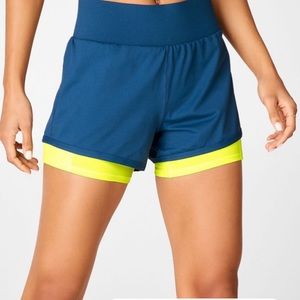 Fabletics Olesia short with pockets. Navy and neon
